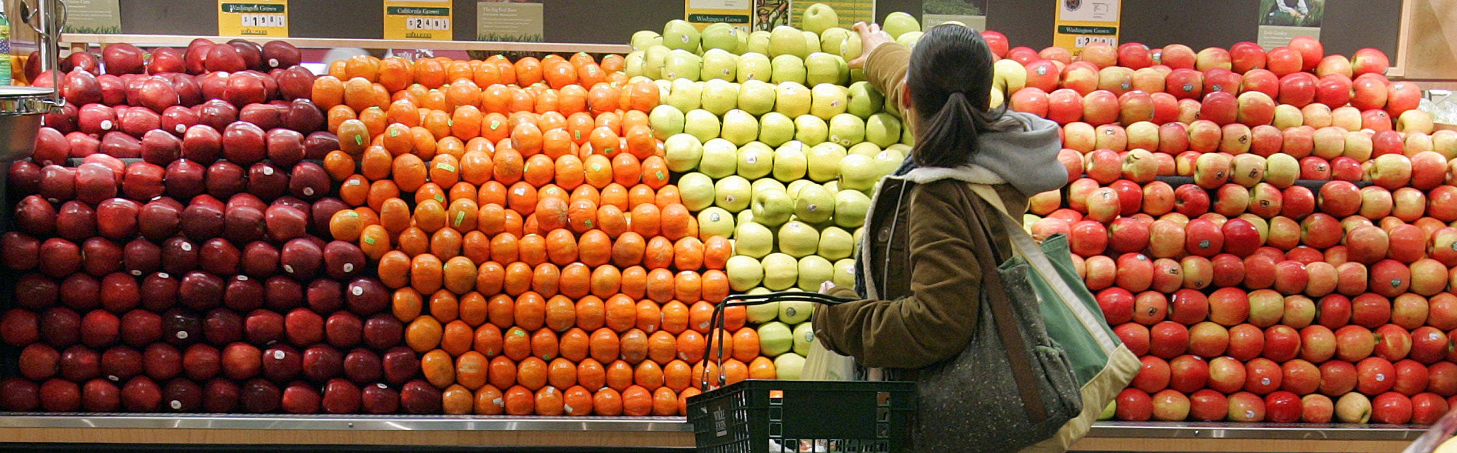 Person in the fruit aisle at grocery store