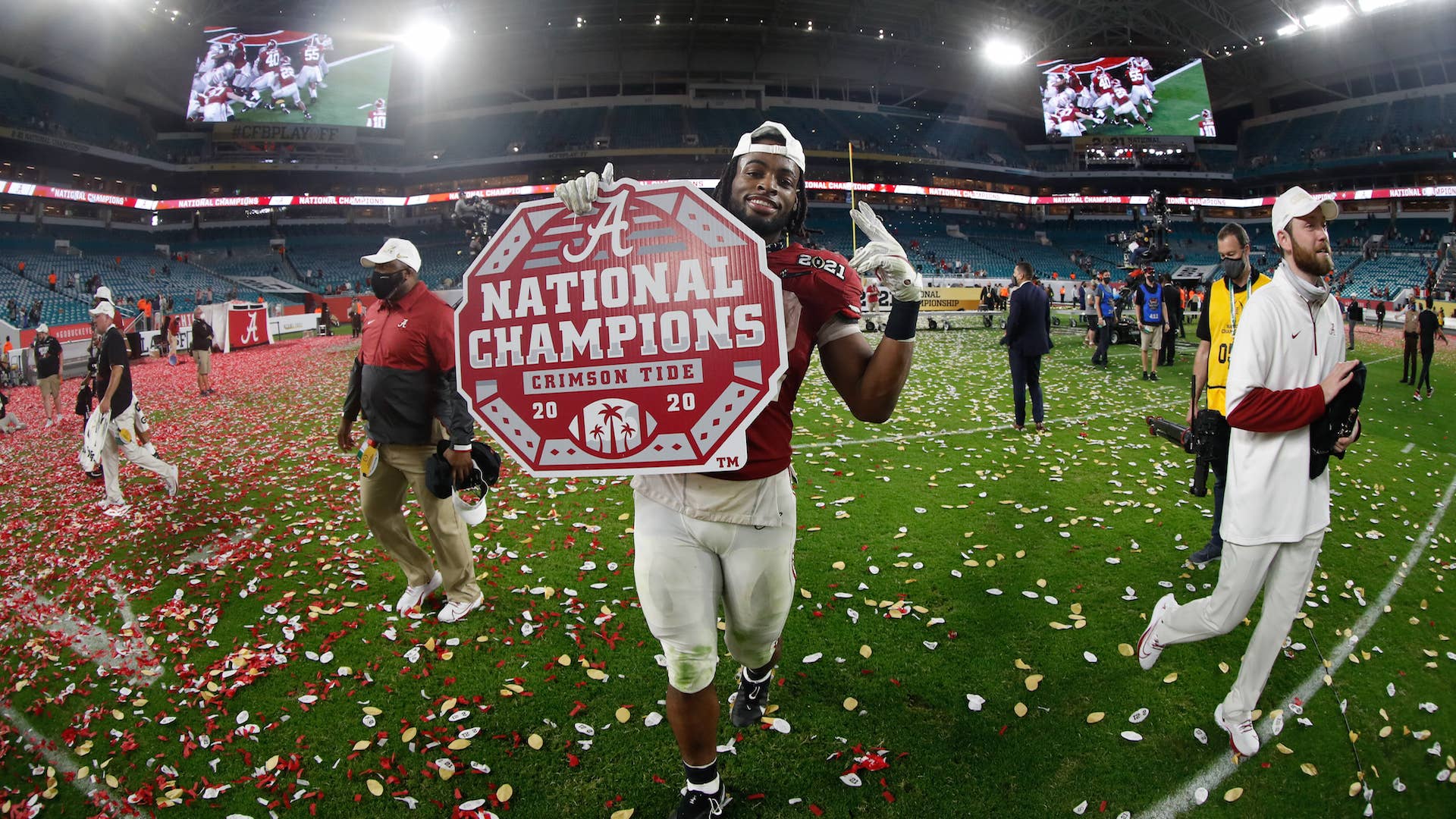 Najee Harris #22 of the Alabama Crimson Tide holds a National Champions sign