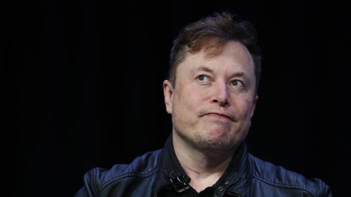 Elon Musk looking stressed at an event.