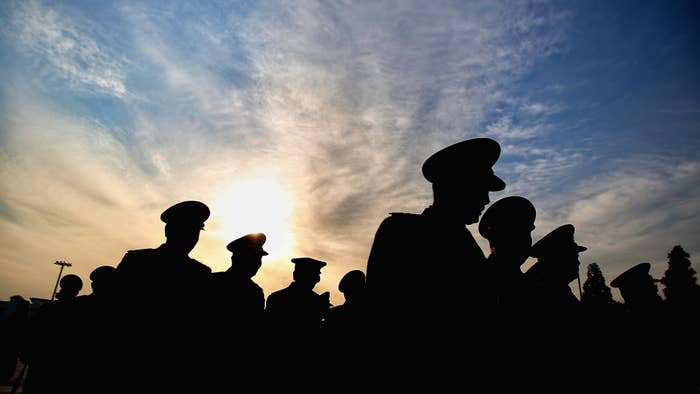 Silhouette of a bunch of unidentifiable military delegates.