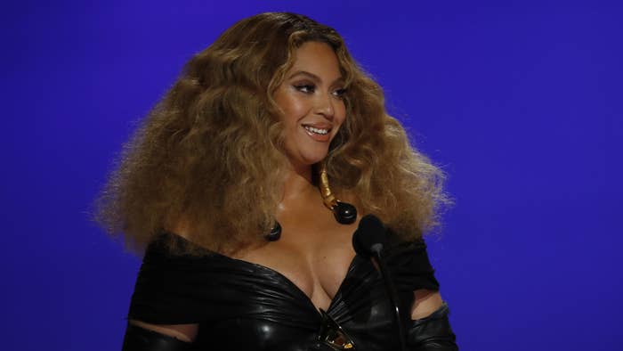 Beyonce is pictured on a stage addressing a crowd