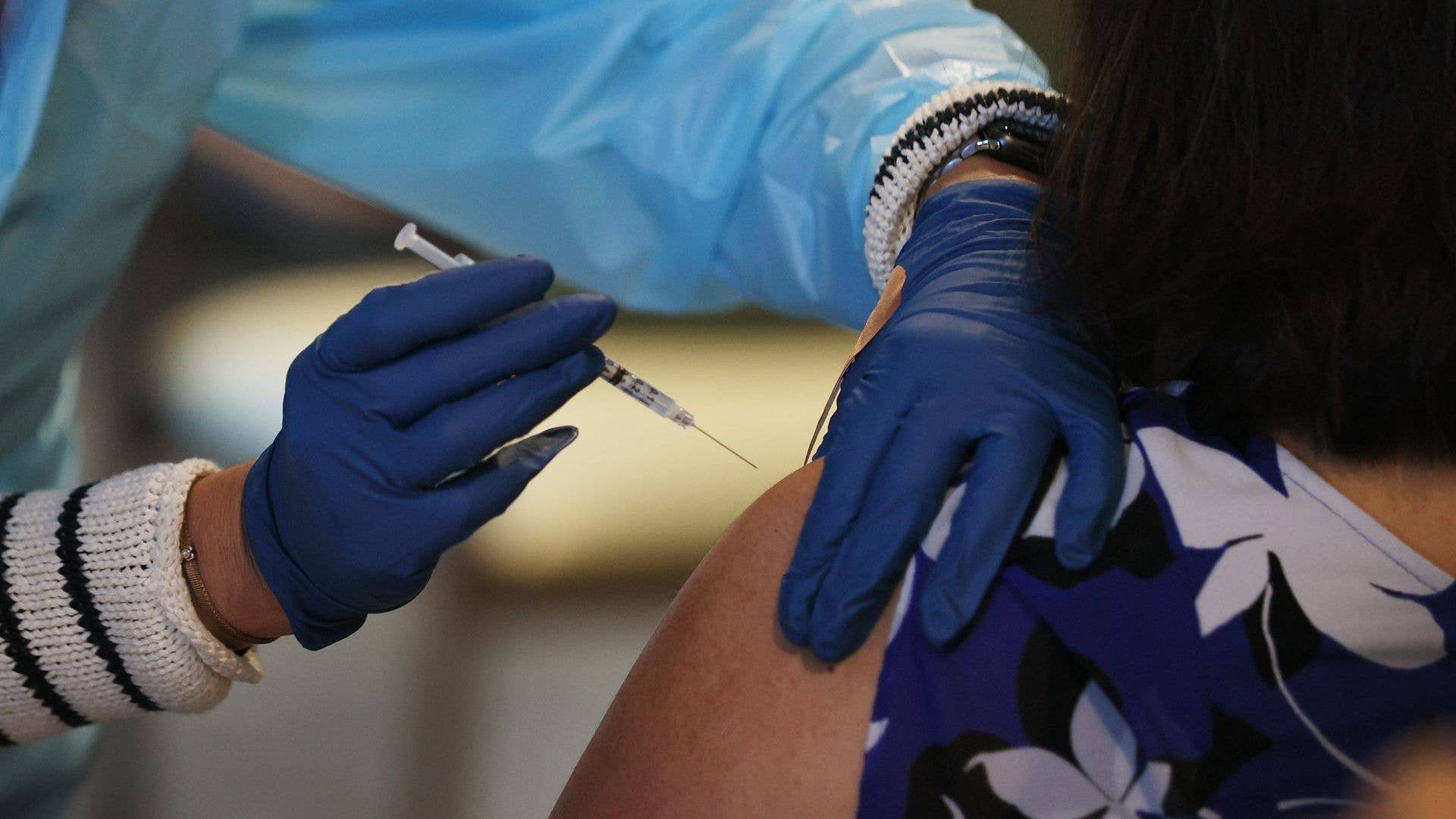 Healthcare worker administers a Pfizer-BioNtech COVID-19 vaccine