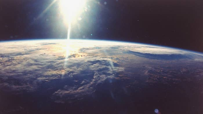 View of sunlight over Earth taken from space shuttle Discovery VIII mission.