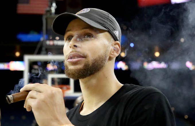 Steph Curry smokes a cigar after winning the 2017 NBA Finals.
