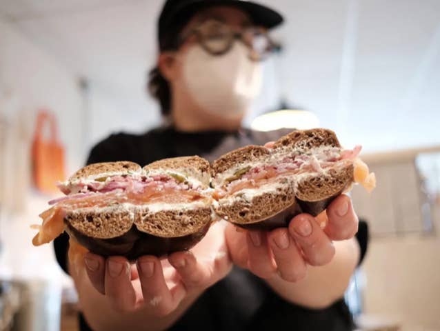 Lev Levine holding a lox bagel