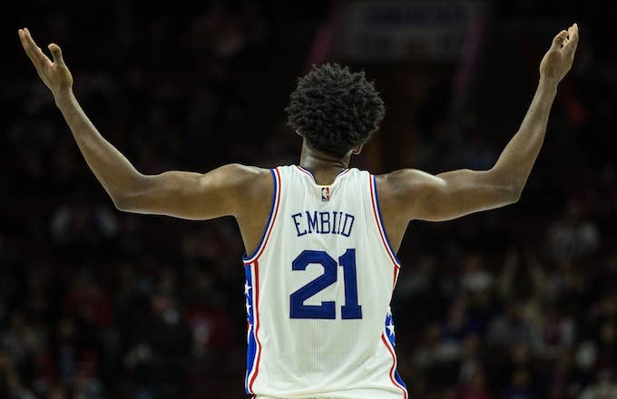Joel Embiid motions for 76ers fans to get off their seats.