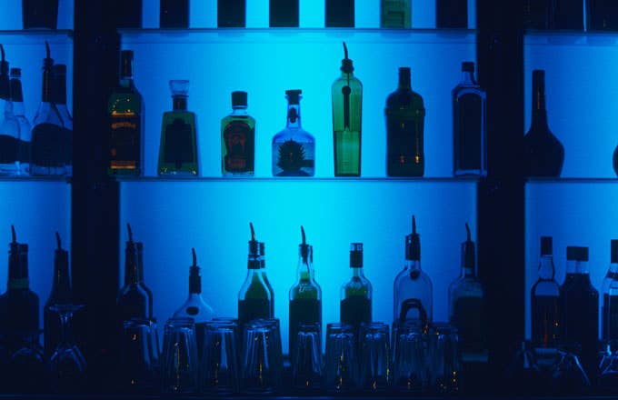 A stock photo of alcohol bottles at a bar.