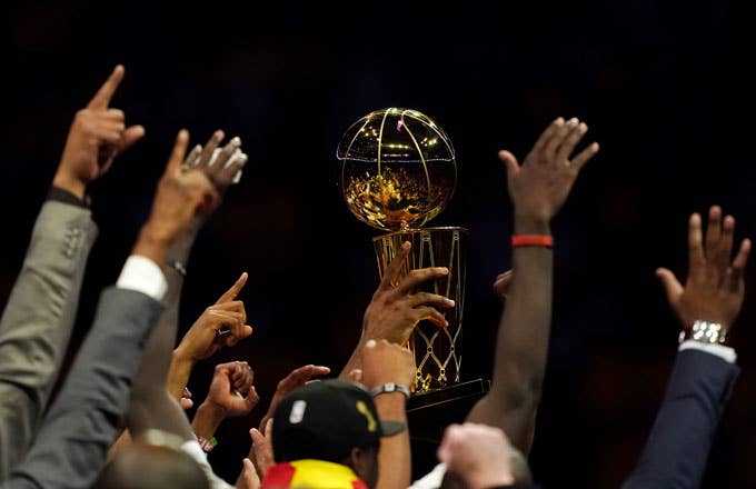 The Raptors hoist the Larry O&#x27;Brien Trophy.