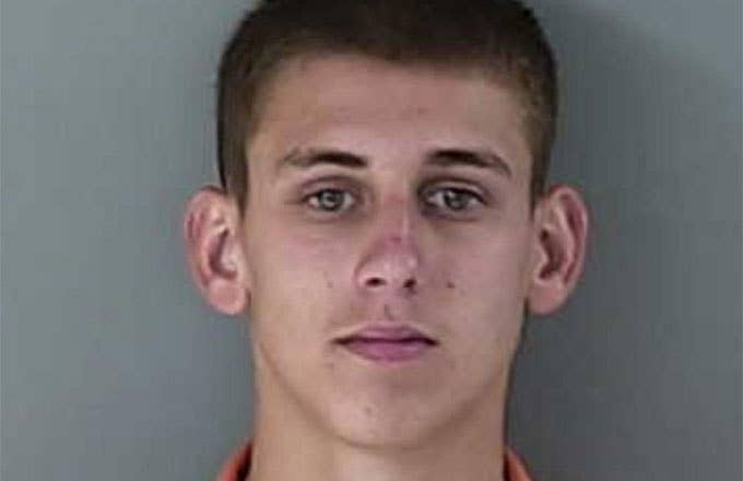 An Idaho teen gets his mugshot taken.