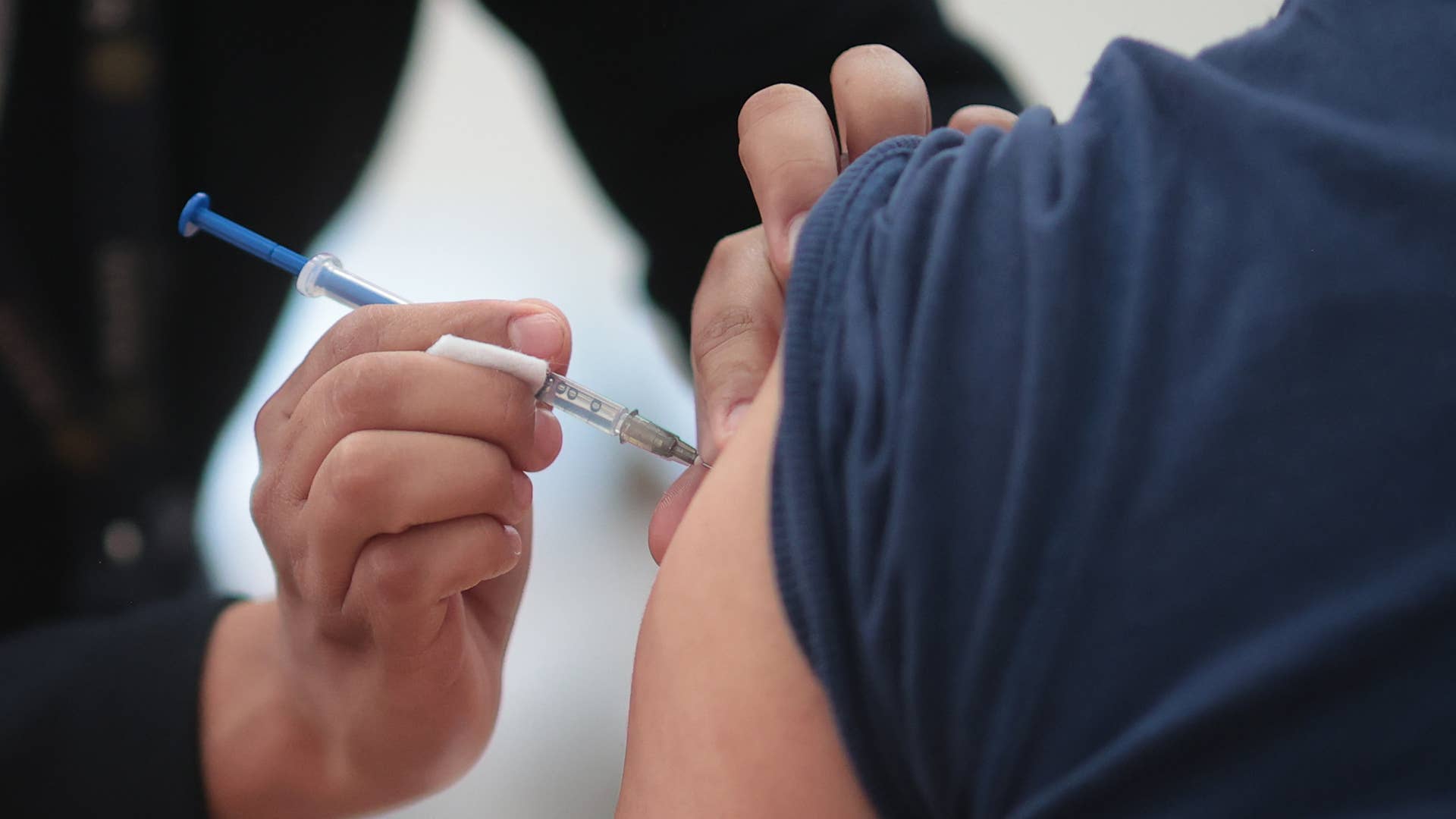 A citizen receives a dose of the vaccine for COVID-19 during a vaccination day.