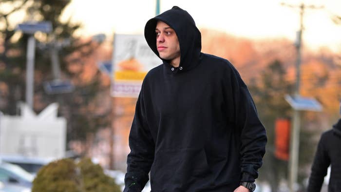 Pete Davidson is seen on a film set wearing a hoodie