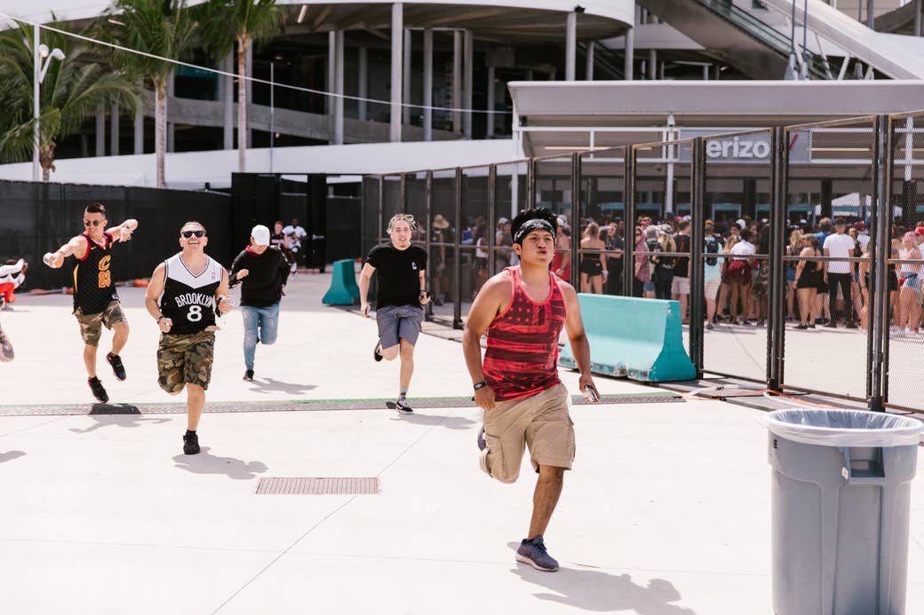Rolling Loud attendees running through festival entrance.