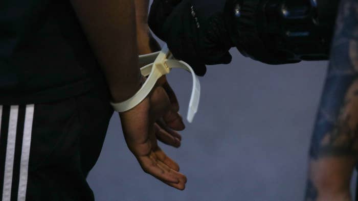 A close up view of a protestor&#x27;s hands in plastic handcuffs after being arrested