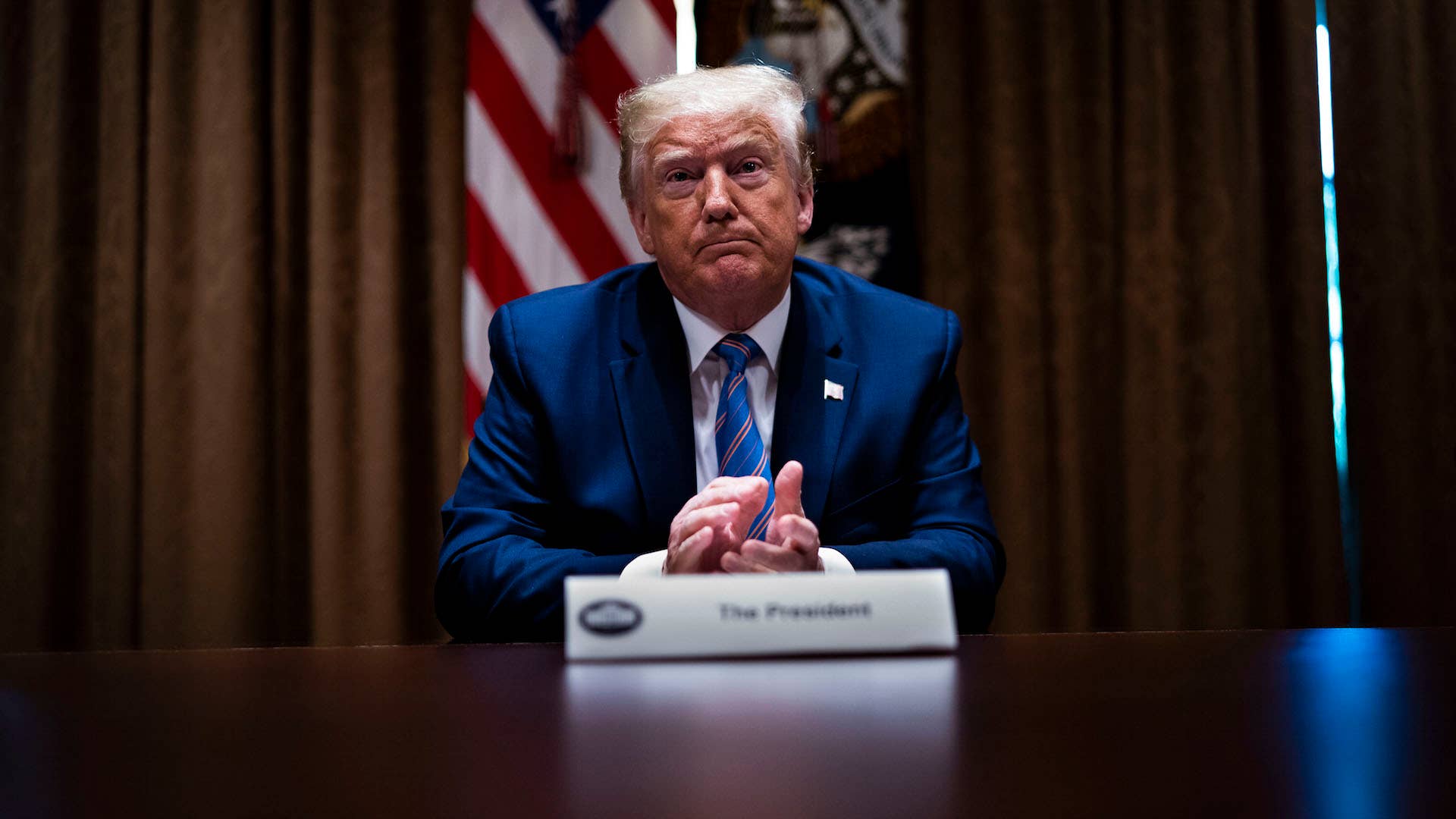 U.S. President Donald Trump listens during a roundtable