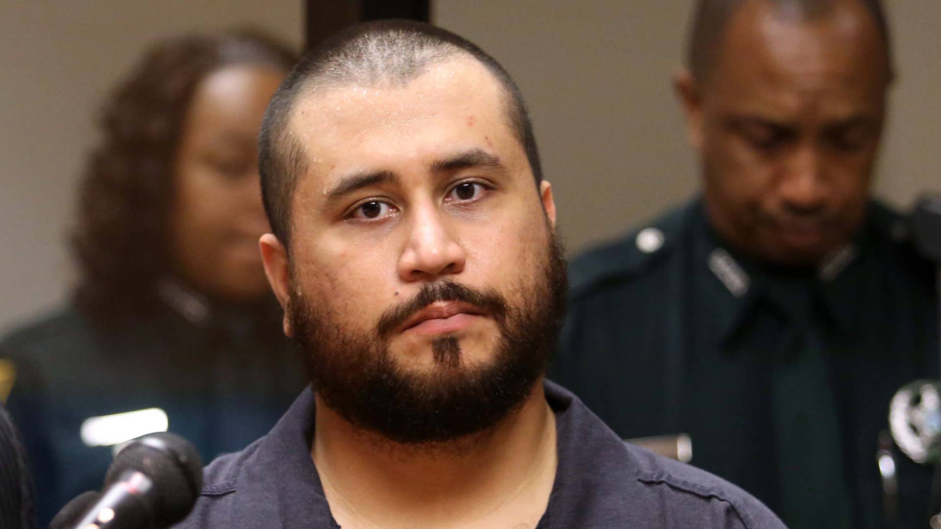 George Zimmerman listens to defense counsel during court appearance.