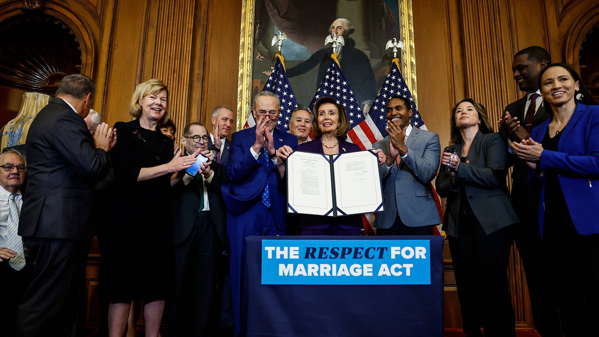 House Speaker Nancy Pelosi (D CA) holds up a copy of the text for the Respect For Marriage Act