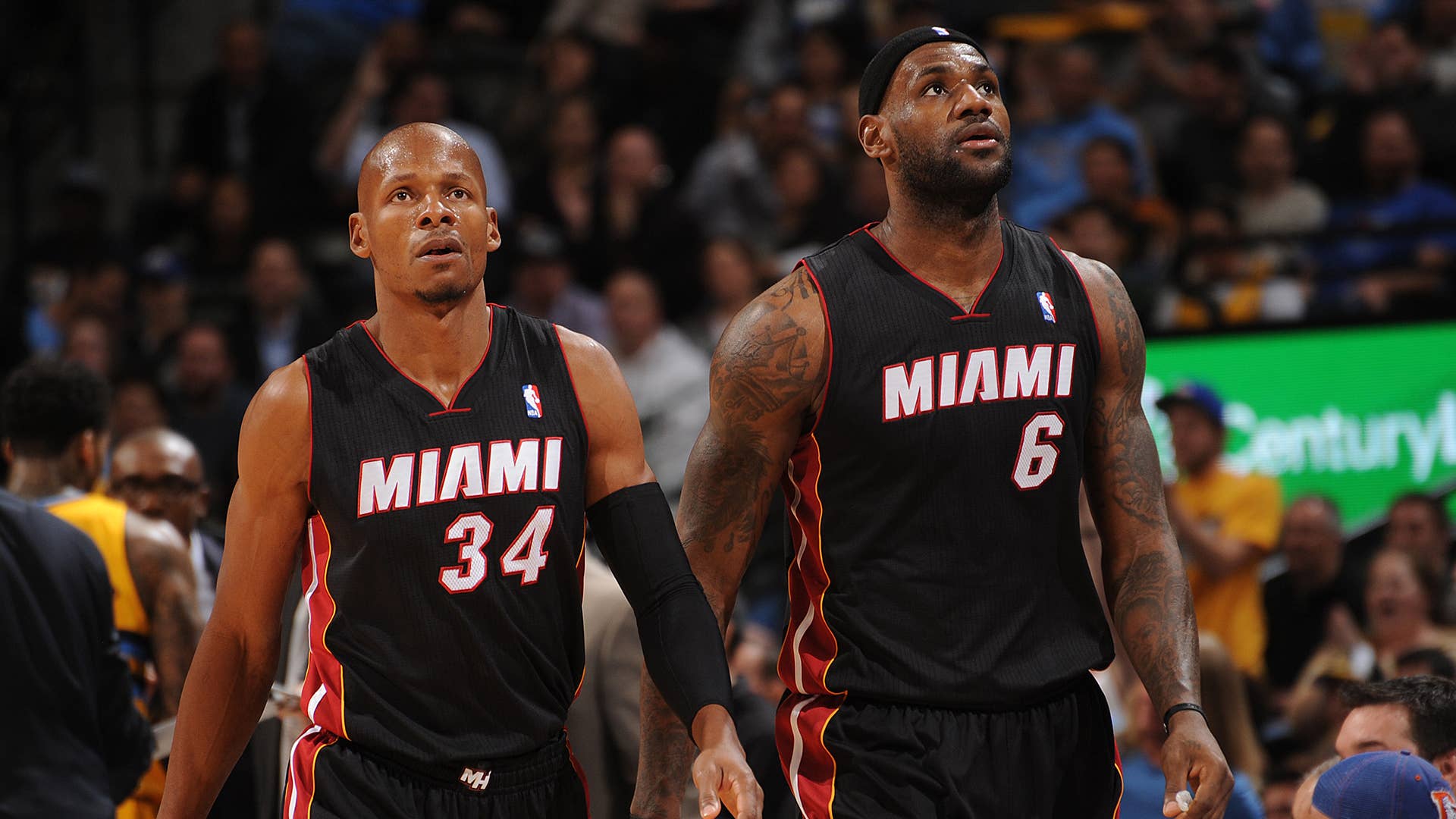 Ray Allen #34 and LeBron James #6 of the Miami Heat look on against the Denver Nuggets