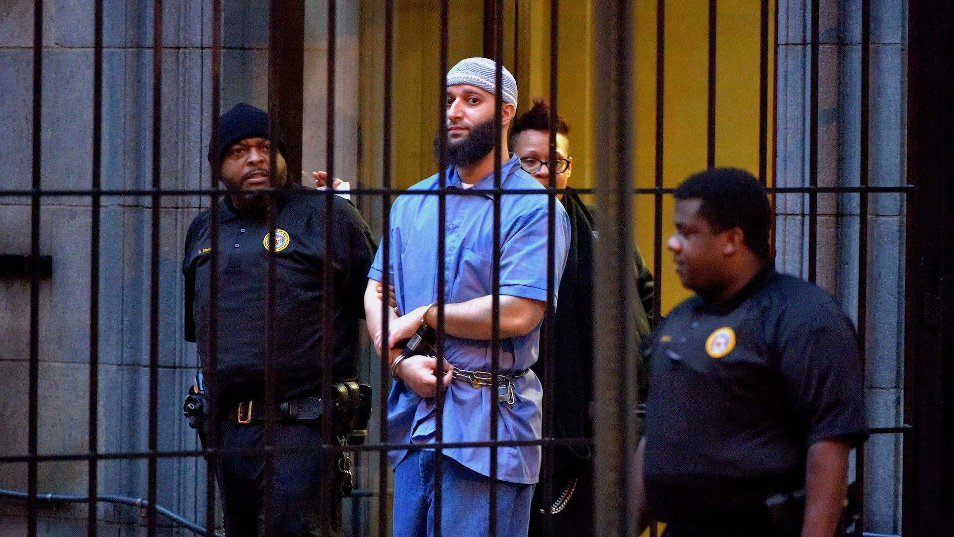 Officials escort "Serial" podcast subject Adnan Syed from the courthouse
