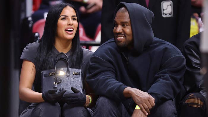 Rapper Kanye West and girlfriend Chaney Jones attend a game between the Miami Heat and the Minnesota Timberwolves