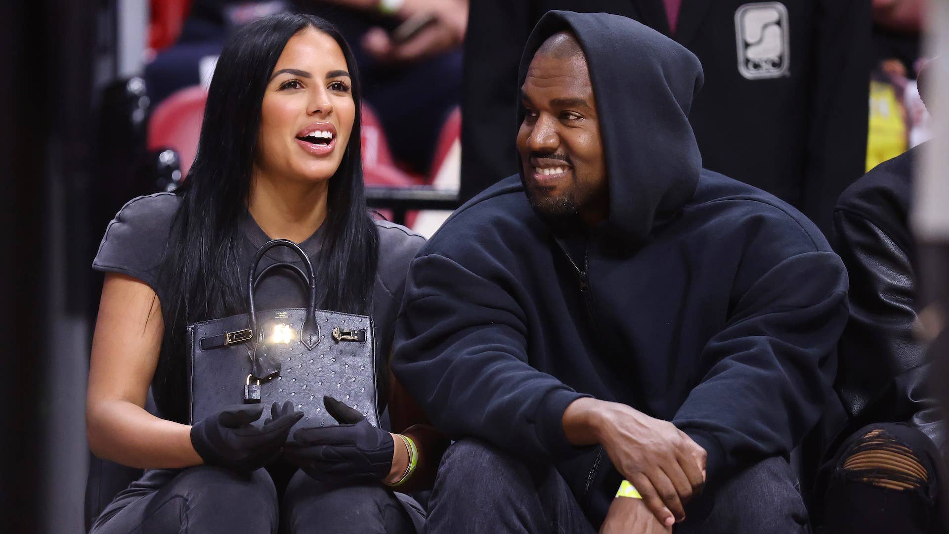 Rapper Kanye West and girlfriend Chaney Jones attend a game between the Miami Heat and the Minnesota Timberwolves