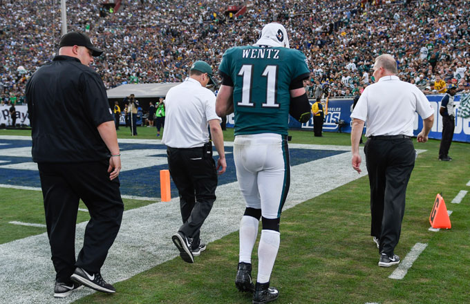Carson Wentz walks off the field with a suspected torn ACL.