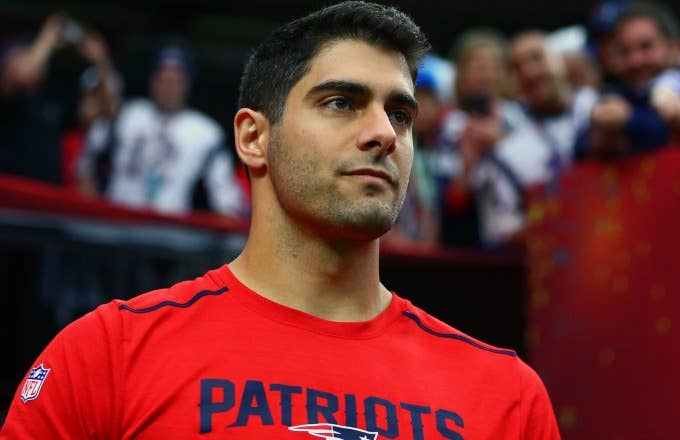 Jimmy Garoppolo stands on the sideline.