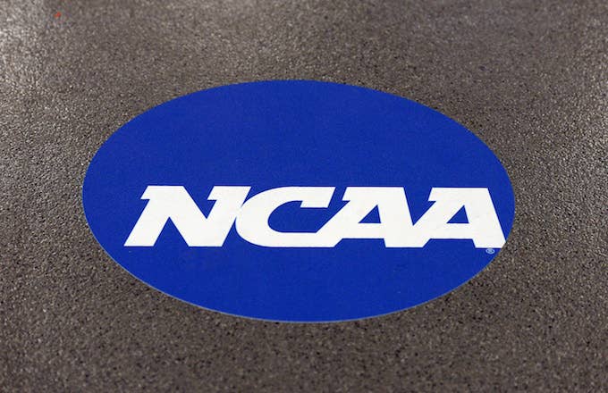 NCAA logo is displayed on the floor during the NCAA Men&#x27;s Gymnastics Championship.