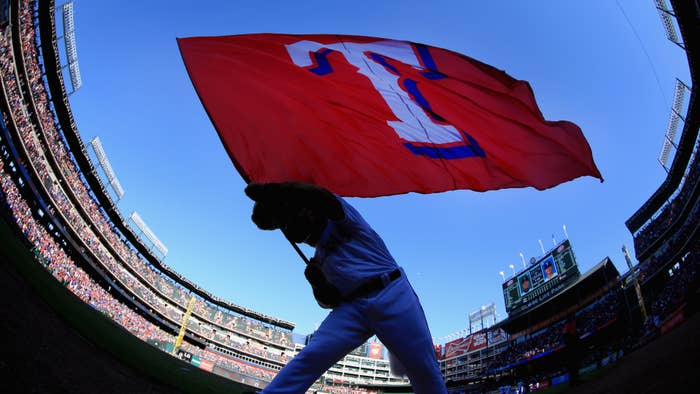 Captain, the Texas Rangers mascot, waves the team flag after the Texas Rangers beat the Seattle Mariners.