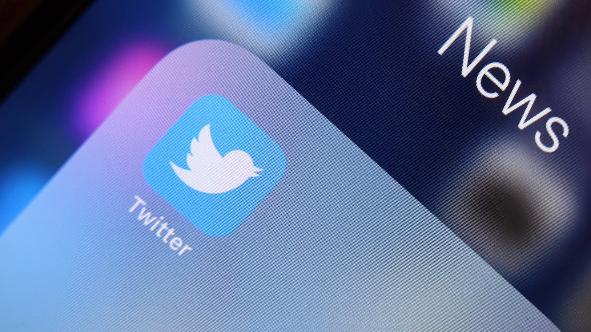 The logo of news platform Twitter is seen on the display of an iPhone.