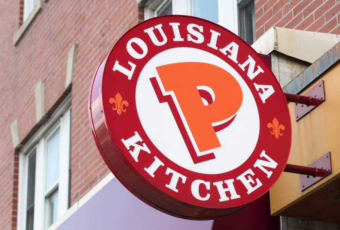 Popeyes Lousiana Kitchen sing or logo outside a restaurant wall.