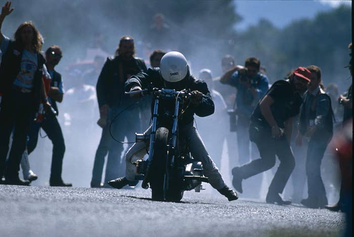 Biker surrounded by people