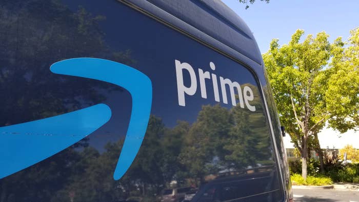 Close-up of logo for Amazon Prime service on the side of a branded delivery truck.