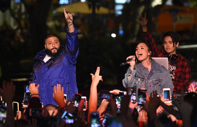 Demi Lovato and DJ Khaled performing together.