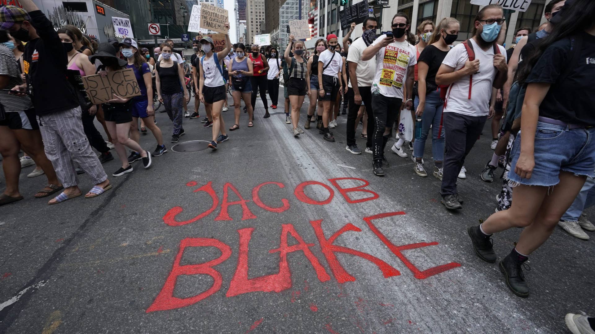 Demonstrators march during a protest in New York against the shooting of Jacob Blake.