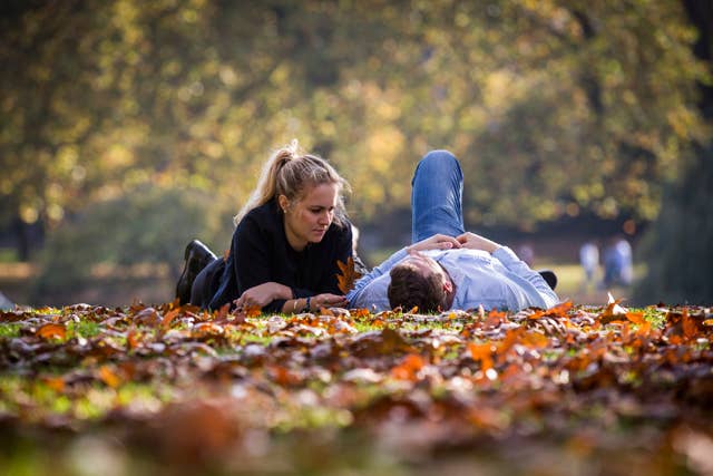 A couple relaxing in St James Park on October 31, 2014 in London, England