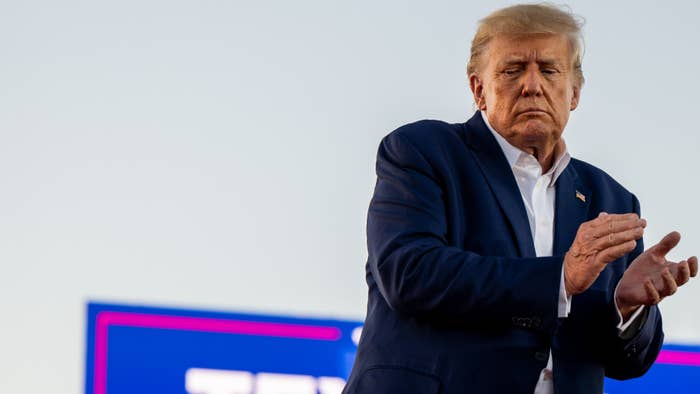 Donald Trump is seen clapping at a rally