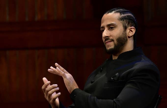 colin kaepernick clapping black suit