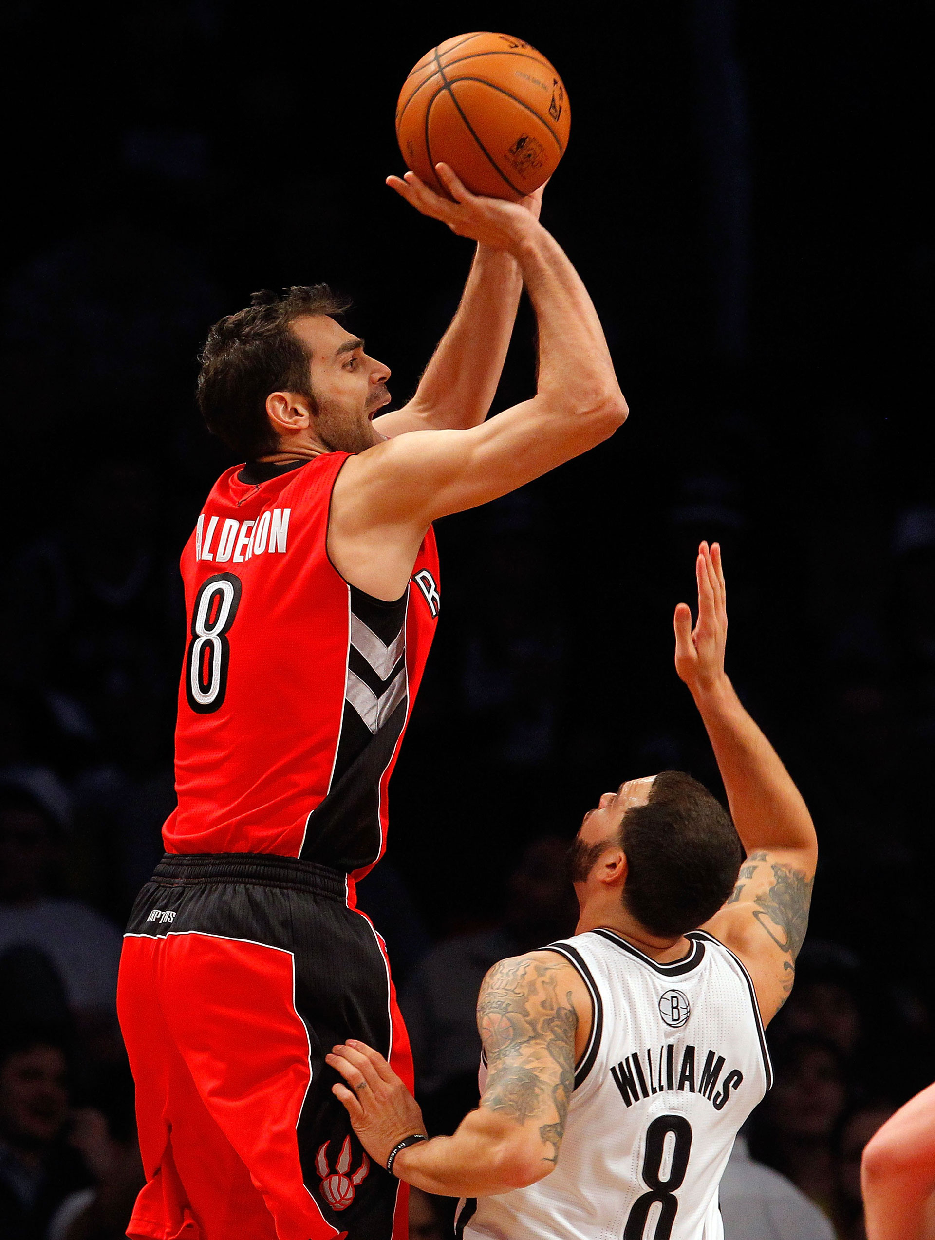 Jose Calderon #8 of the Toronto Raptors in action against Deron Williams #8 of the Brooklyn Nets