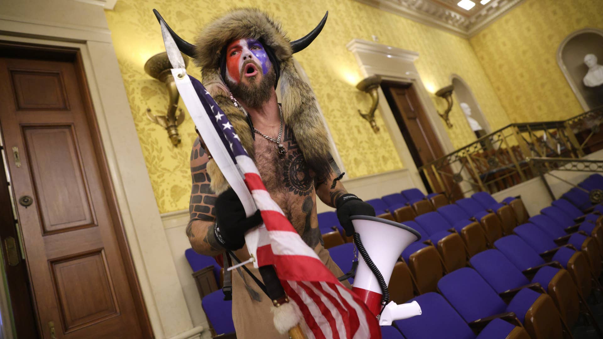 Protester screams "Freedom" inside the Senate chamber after the U.S. Capitol was breached.