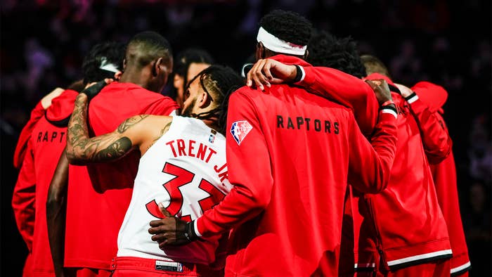 Gary Trent Jr and Pascal Siakam and other Toronto Raptors join in group huddle.