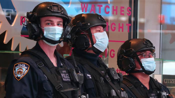 NYPD police officers wear masks as they stand guard in Times Square