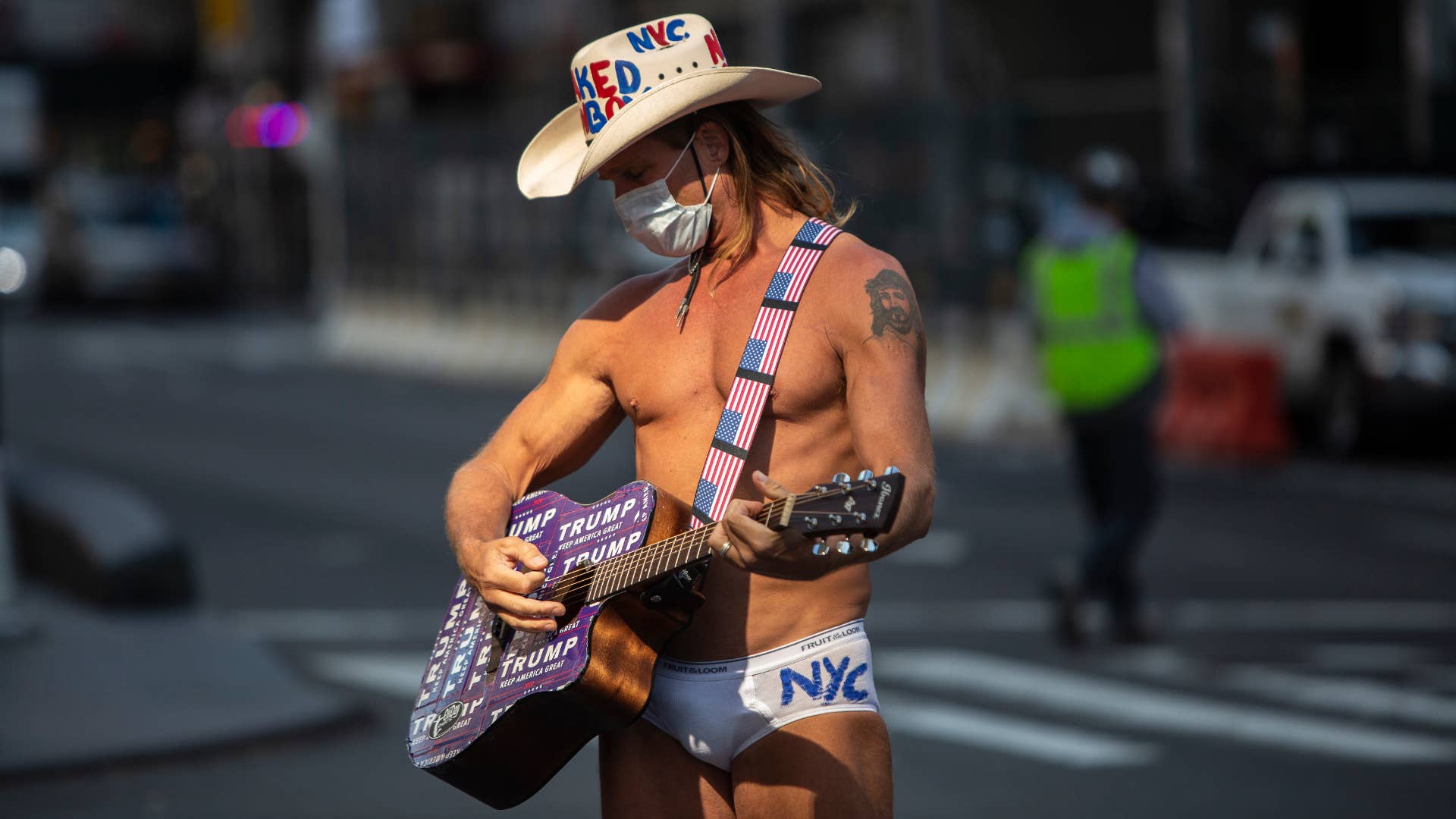 The Naked Cowboy greets tourists as Times Square is mostly empty.