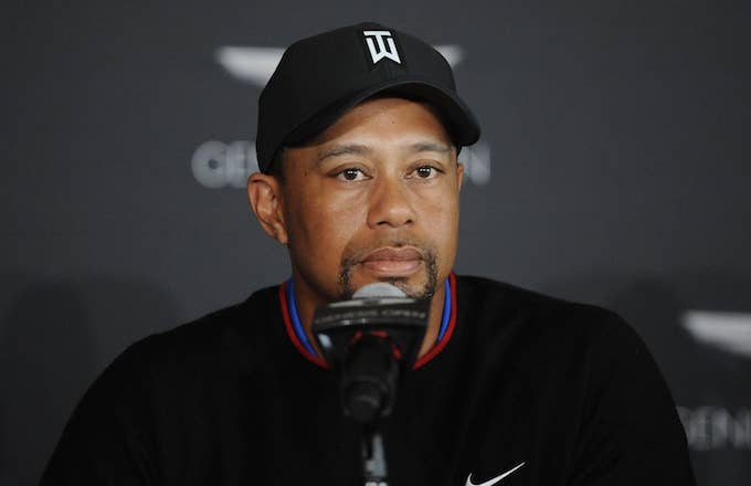Tiger Woods speaks with reporters.
