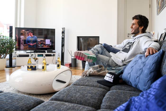 The wax figure of the actor Elyas M&#x27;Barek is shown in a scene on a couch while watching television