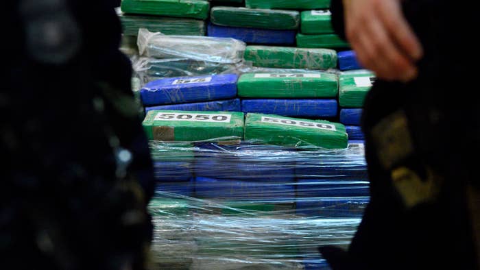 Guards stand in front of part of the evidence from a cocaine bust.