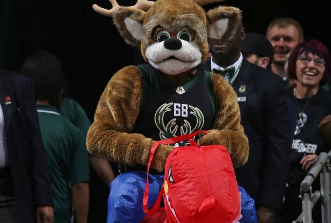 Bucks mascot rides an inflatable Raptor.