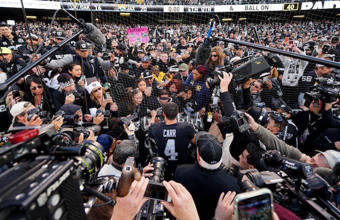 Derek Carr signs autographs for young fans after the game against the Jaguars.