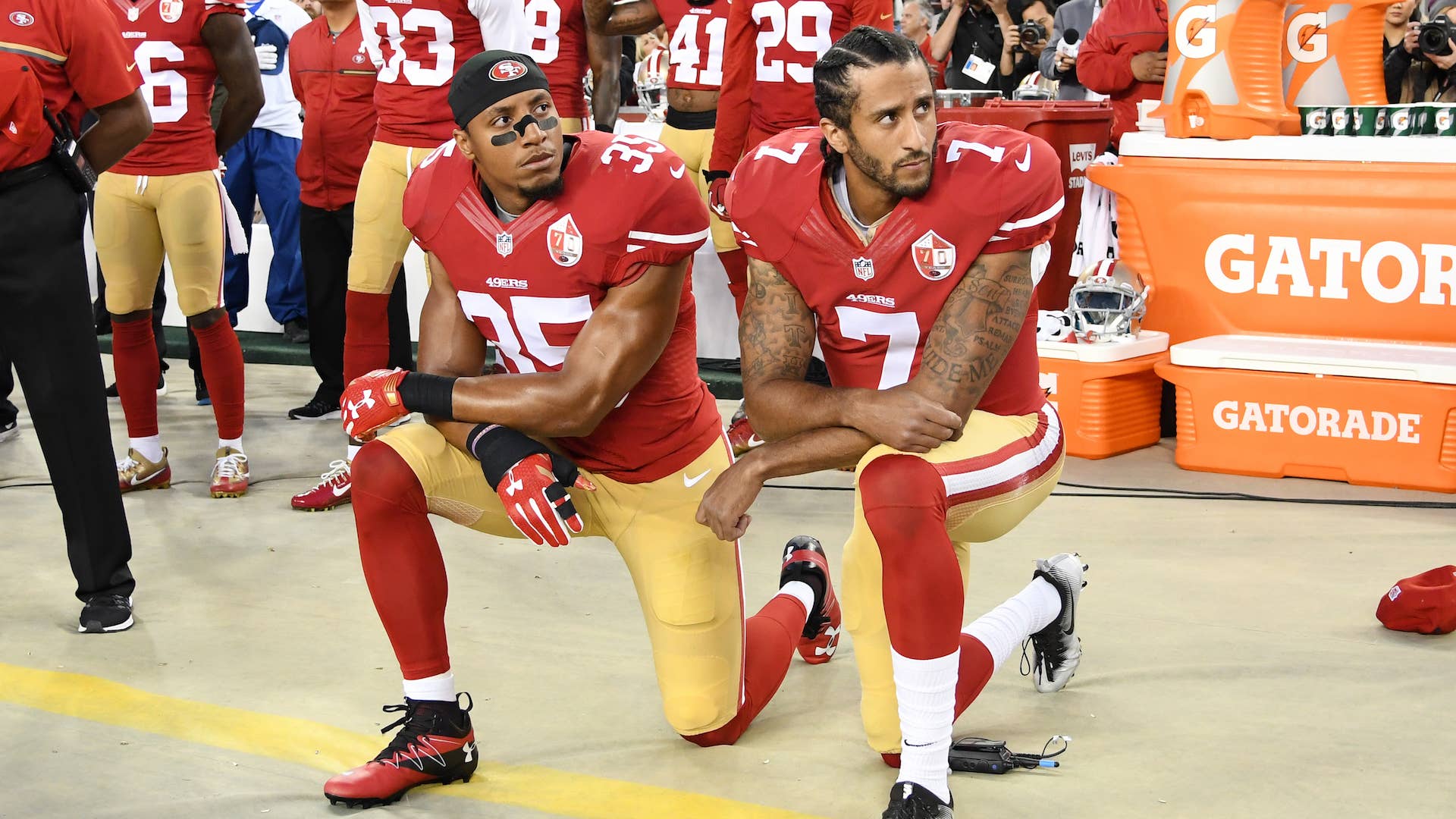 Colin Kaepernick and Eric Reid kneel in protest during the national anthem.