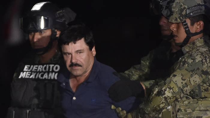 Joaquin &quot;El Chapo&quot; Guzman is escorted to a helicopter.