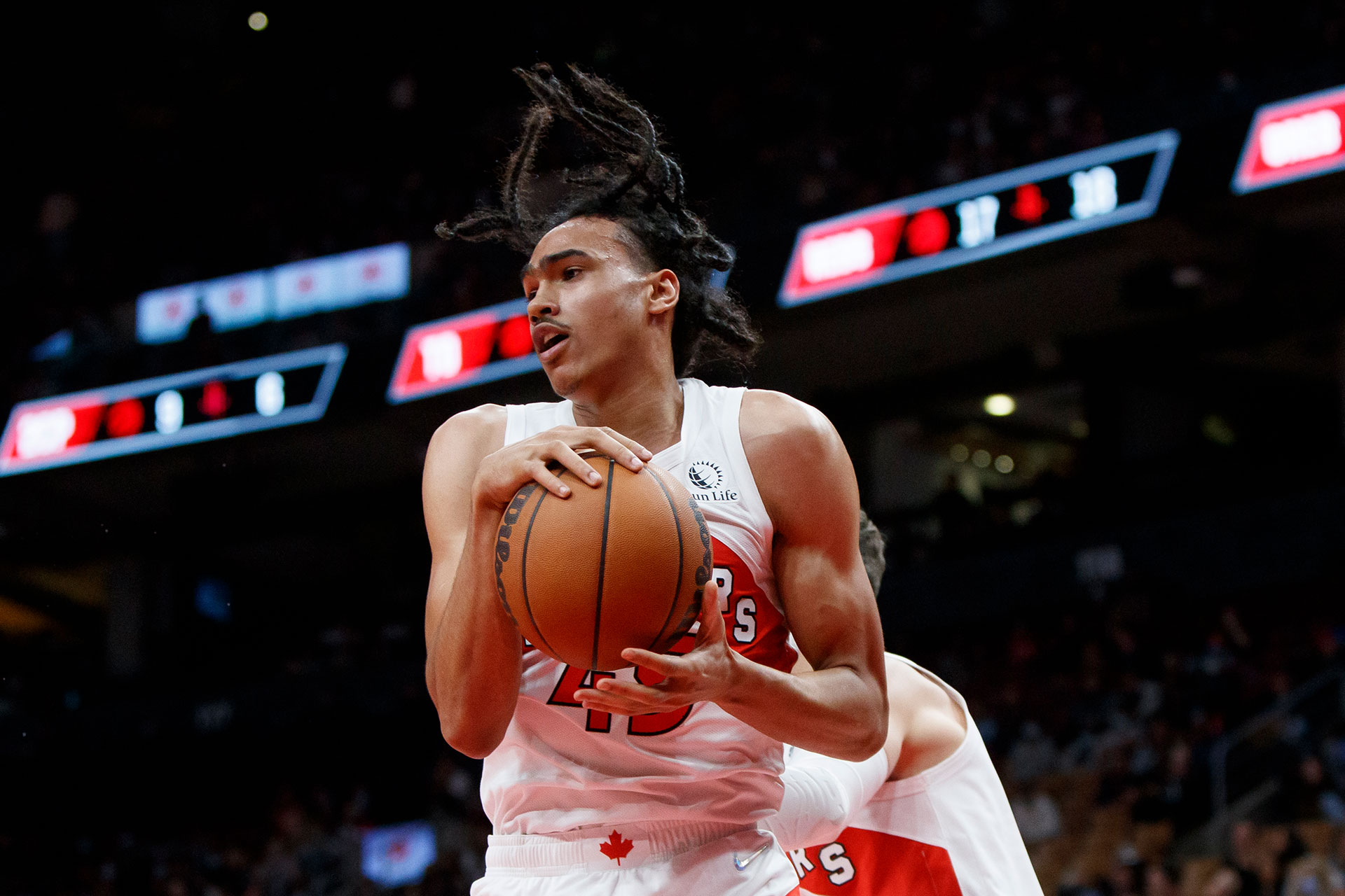 Dalano Banton #45 of the Toronto Raptors grabs a rebound during preseason NBA game action at Scotiabank Arena on October 11, 2021 in Toronto, Canada.